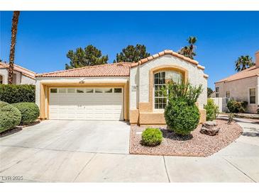 Charming single-story home featuring a two-car garage and desert landscaping at 2608 Port Of Call Dr, Las Vegas, NV 89128