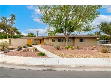 Charming single-story home with desert landscaping and a walkway leading to a bright yellow front door at 3597 Cochise Ln, Las Vegas, NV 89169