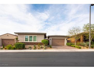Charming single-story home with well-manicured landscaping and brick paved driveway at 408 Middlestone Ave, Henderson, NV 89011