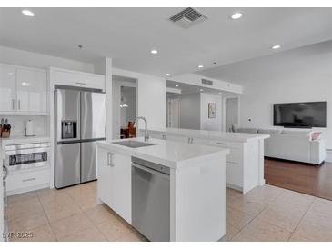 Modern kitchen features stainless steel appliances, white cabinetry and countertops, and a spacious island at 4525 Dean Martin Dr # 3006, Las Vegas, NV 89103