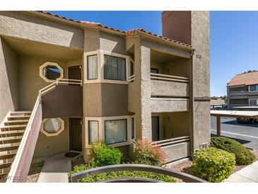 Attractive condo featuring a private balcony, beautiful landscaping, and convenient covered parking at 5032 S Rainbow Blvd # 206, Las Vegas, NV 89118