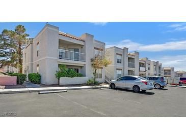 Inviting exterior of multi-Gathering apartment building with private balconies and ample parking at 6800 E Lake Mead Blvd # 2050, Las Vegas, NV 89156