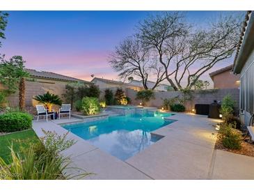 Beautiful backyard pool and spa with lush landscaping and hardscape provides a relaxing retreat at 7181 Barton Creek Ct, Las Vegas, NV 89113