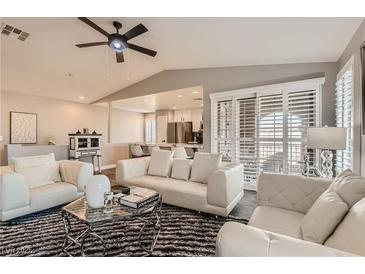 Bright living room with neutral walls, a ceiling fan, and large windows, perfect for entertaining at 7250 Diamond Canyon Ln # 204, Las Vegas, NV 89149