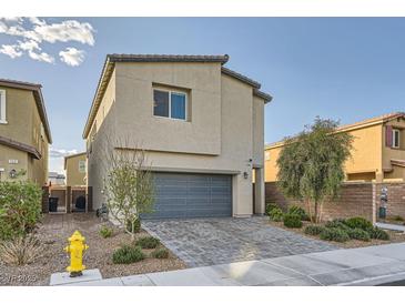 Charming two-story home featuring a gray garage door and a well-manicured front yard at 7605 Moore Creek Ln, North Las Vegas, NV 89084