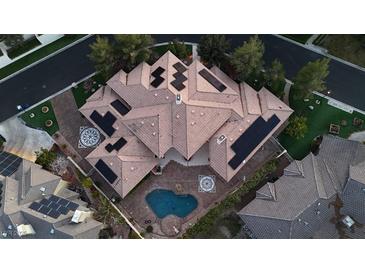 Stunning aerial view of a home featuring solar panels, a backyard pool, and manicured landscaping at 3008 Astoria Pines Cir, Las Vegas, NV 89107