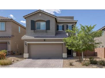 Inviting two-story home with a well-manicured front yard and a two-car garage at 5589 Pico Ferrera Ct, Las Vegas, NV 89113