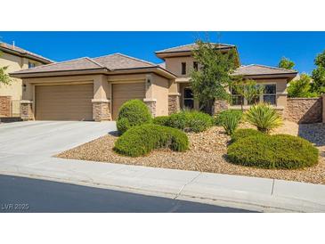 Charming single-story home showcasing a three-car garage, desert landscaping, and a tile roof at 3908 Specula Wing Dr, North Las Vegas, NV 89084