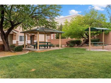 Inviting community park featuring picnic tables and lush green lawns, perfect for outdoor gatherings at 6045 Riverwalk Falls St # 102, North Las Vegas, NV 89031