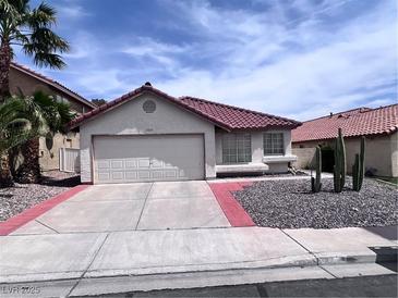 Charming single-story home featuring a red tile roof, desert landscaping, and an attached two-car garage at 3324 Haven Beach Way, Las Vegas, NV 89117