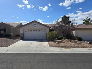 Charming single-story home with a two-car garage and low-maintenance desert landscaping in a sunny day at 415 Golden State St, Henderson, NV 89012