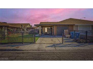 Charming single-story home featuring a gated front yard and covered parking at 7047 Mountain Meadow Ln, Las Vegas, NV 89147