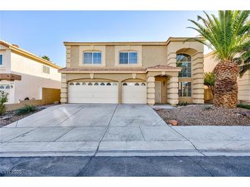 Two-story home featuring a desert landscape, three-car garage and well-maintained lawn at 8617 Copper Ridge Ave, Las Vegas, NV 89129