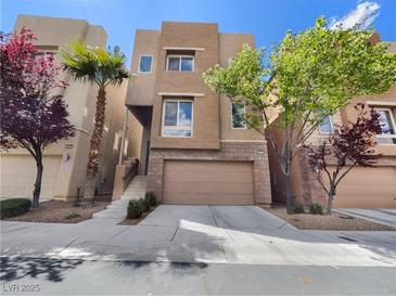 Inviting two-story home with a two-car garage and desert landscaping at 9267 Lapeer St, Las Vegas, NV 89178