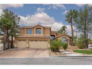 Charming two-story home featuring a three-car garage, desert landscaping, and a beautiful red tile roof at 10325 Falls Church Ave, Las Vegas, NV 89144
