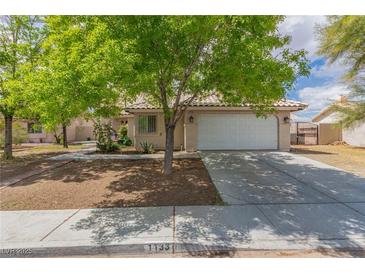 Charming single-story home features a tile roof, desert landscaping, and a two-car garage at 1133 Mount Olympias Ct, Las Vegas, NV 89110