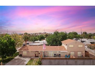 Charming single-story home with a well-maintained yard, a fenced backyard and an American flag at 1200 I Ave, Boulder City, NV 89005