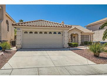 Charming single-story home featuring a tile roof, well-manicured landscaping, and a spacious two-car garage at 1751 Juniper Twig Ave, Las Vegas, NV 89183