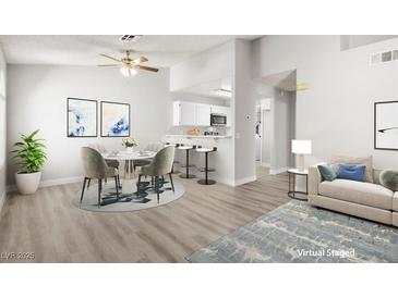 Bright living and dining area featuring contemporary furnishings and open kitchen access at 1800 Edmond St # 226, Las Vegas, NV 89146