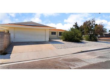 Single-story home featuring a two-car garage, low maintenance landscaping, and a neutral color palette at 1905 Aquarius Dr, Las Vegas, NV 89102