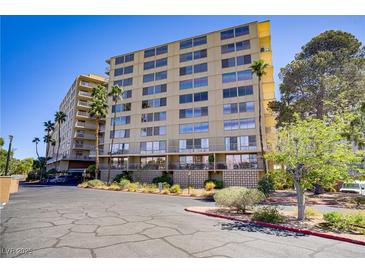 Condominium building exterior showcases a multi-story facade with palm trees and well-maintained landscaping at 205 E Harmon Ave # 306, Las Vegas, NV 89169
