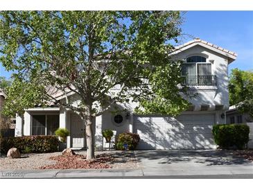 Charming two-story home features a well-manicured front yard and a two-car garage, inviting curb appeal at 2305 Flower Spring St, Las Vegas, NV 89134