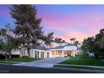 Elegant home featuring a lush front lawn, large shade trees and attached three car garage at 2316 Prometheus Ct, Henderson, NV 89074