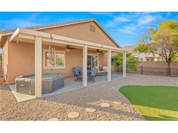 Relaxing backyard with a covered patio, hot tub, and seating area with ample room for entertainment at 2720 Mickey Mantle Ct, Las Vegas, NV 89108