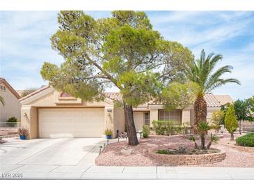 Charming single-story home boasts a desert landscape, mature trees and an attached two car garage at 2737 Tumble Brook Dr, Las Vegas, NV 89134