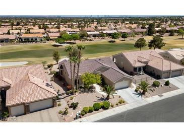 Beautiful single-story home with well-maintained landscaping and tile roof, surrounded by lush green golf course at 3016 High Range Dr, Las Vegas, NV 89134