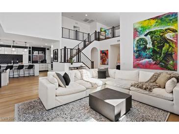 Bright, open living room with modern decor and staircase leading to the second floor at 3038 Villanelle Ave, Henderson, NV 89044