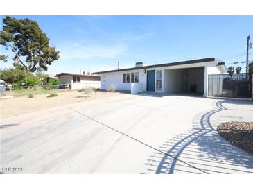 Charming single-story home featuring a covered carport and a spacious driveway at 3115 Wright Ave, North Las Vegas, NV 89030
