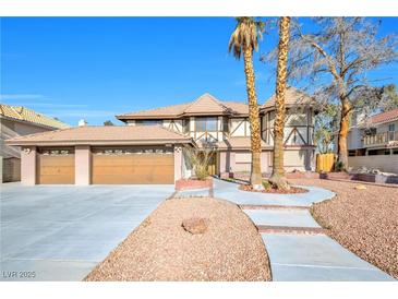 Charming home featuring a three-car garage and a landscaped yard with mature trees and a stone walkway at 3382 Montessouri, Las Vegas, NV 89117