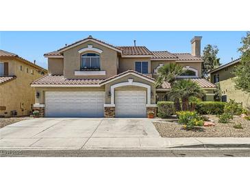 Charming two-story home featuring a three-car garage, arched windows and well-maintained landscaping at 3749 Climbing Rose St, Las Vegas, NV 89147