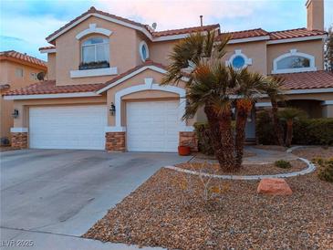 Charming two-story home with a three-car garage and desert landscaping showcasing beautiful curb appeal at 3749 Climbing Rose St, Las Vegas, NV 89147