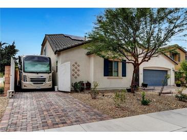 Charming single-story home with desert landscaping, RV parking and a brick driveway at 8811 Pauley Hills St, Las Vegas, NV 89131