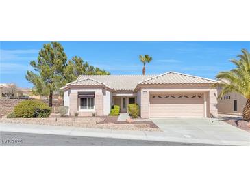 Charming single-story home featuring desert landscaping, tile roof, and an attached two-car garage at 10920 Black Ledge Ave, Las Vegas, NV 89134