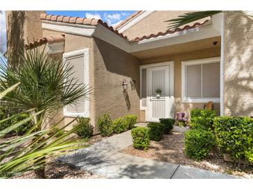 Charming front entrance features a well-maintained garden and a welcoming white front door at 2037 Summer Blossom Ct # 101, Las Vegas, NV 89134