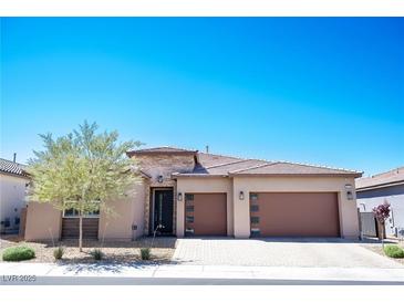 Charming single-story home with a two-car garage, desert landscaping, and a stone accent facade at 2719 Canvas Sky St, Henderson, NV 89044