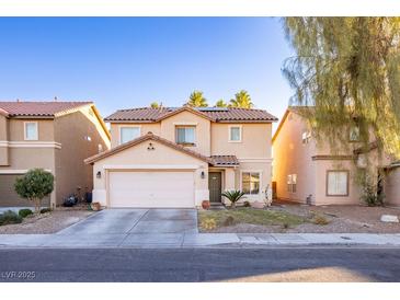 Charming two-story home featuring a manicured lawn and a two-car garage with desert landscaping at 5031 Naff Ridge Dr, Las Vegas, NV 89131