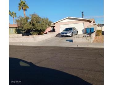 Single story house with desert landscaping, two car garage, and a silver car parked in driveway at 5324 Del Monte Ave, Las Vegas, NV 89146