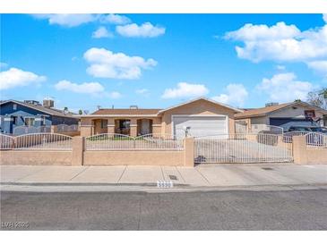 Charming single-story home with a spacious front yard and white wrought iron fence at 5530 Berchmans Ave, Las Vegas, NV 89122