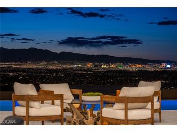 Stunning Las Vegas city view from the outdoor seating area at night at 667 Palisade Rim Dr, Henderson, NV 89012