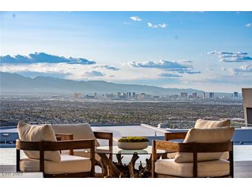Expansive city views from this gorgeous patio with comfortable seating and clear skies at 667 Palisade Rim Dr, Henderson, NV 89012