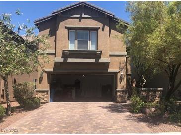 Inviting two-story home with a brick-paved driveway and an attached two-car garage at 7342 Tanglewood Park St, Las Vegas, NV 89166