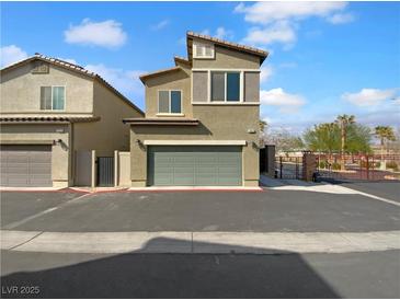 Two story tan home with a two car garage and desert landscaping at 7452 Sunray Point St, North Las Vegas, NV 89084