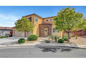 Charming two-story home with desert landscaping, stone accents, arched entry, and a two car garage at 9413 Artesian Oak Ct, Las Vegas, NV 89149