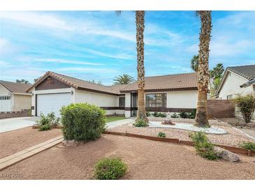 Charming single-story home with tidy front yard, palm trees, and easy-care landscaping at 1837 Alicant Way, Henderson, NV 89014
