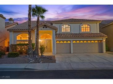 Charming two-story home boasting a tile roof, three-car garage, and professionally landscaped front yard at 2445 Antler Point Dr, Henderson, NV 89074