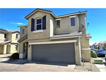 Two-story tan home with a two-car garage, brown shutters, and well-kept landscaping at 6348 Blue Twilight Ct, Las Vegas, NV 89108